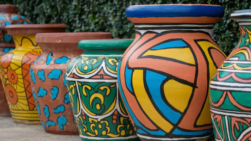 Beautifully painted terracotta garden containers, a great choice for some plants, not for others.