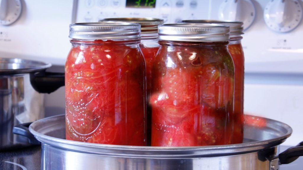 Four jars of preserved stew tomatoes. 